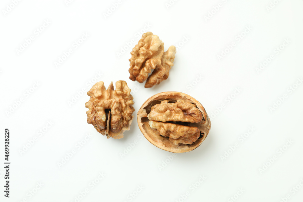 Walnuts with nutshell on white background, close up Walnuts with nutshell on white background, close up
