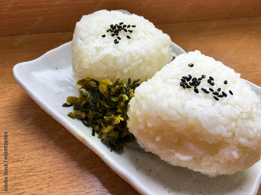 Two rice balls Onigiri with Kuro Goma (sesame) with Takana (Takanazuke