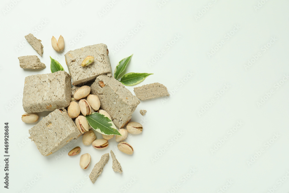 Halva with pistachio and leaves on white background