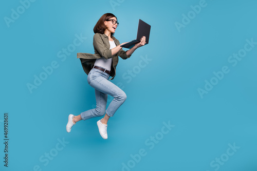 Photo Profile side full size photo of excited lady ceo jump chatting netbook ap wear d