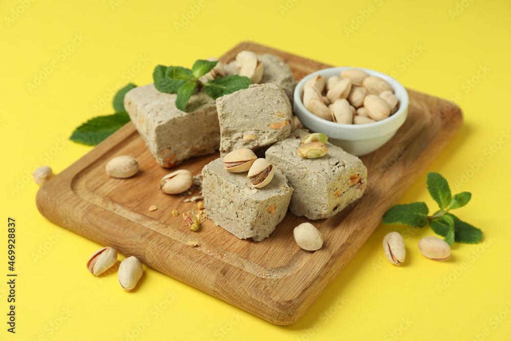 Concept of tasty food with halva on yellow background
