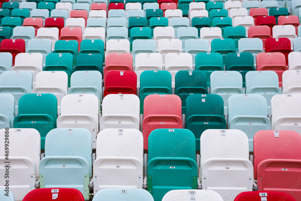 Obraz premium colored chairs at the football stadium. red green white