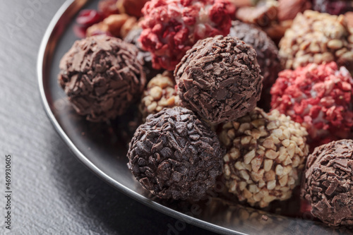 Chocolate candies with, nuts and dried strawberries. © Igor Normann