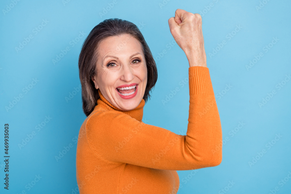 Fototapeta premium Profile portrait of overjoyed lucky person raise fist shout scream yes hooray isolated on blue color background