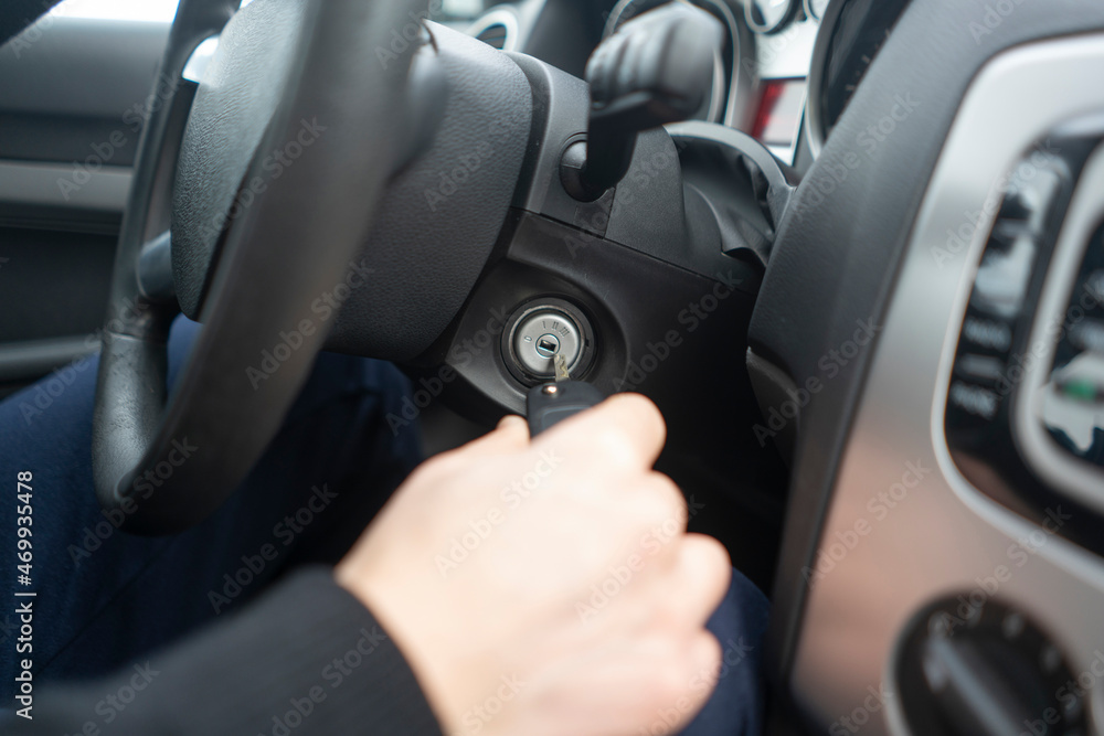 driver with car keys starting the vehicle ignition