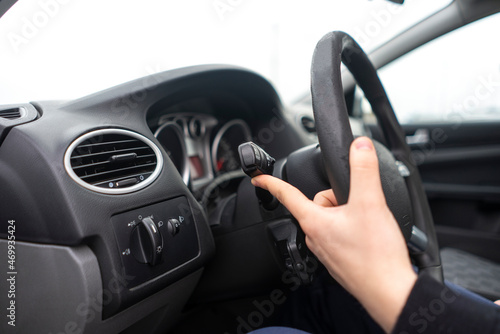 car driver hand push the button and activate windscreen wipers © Mihail