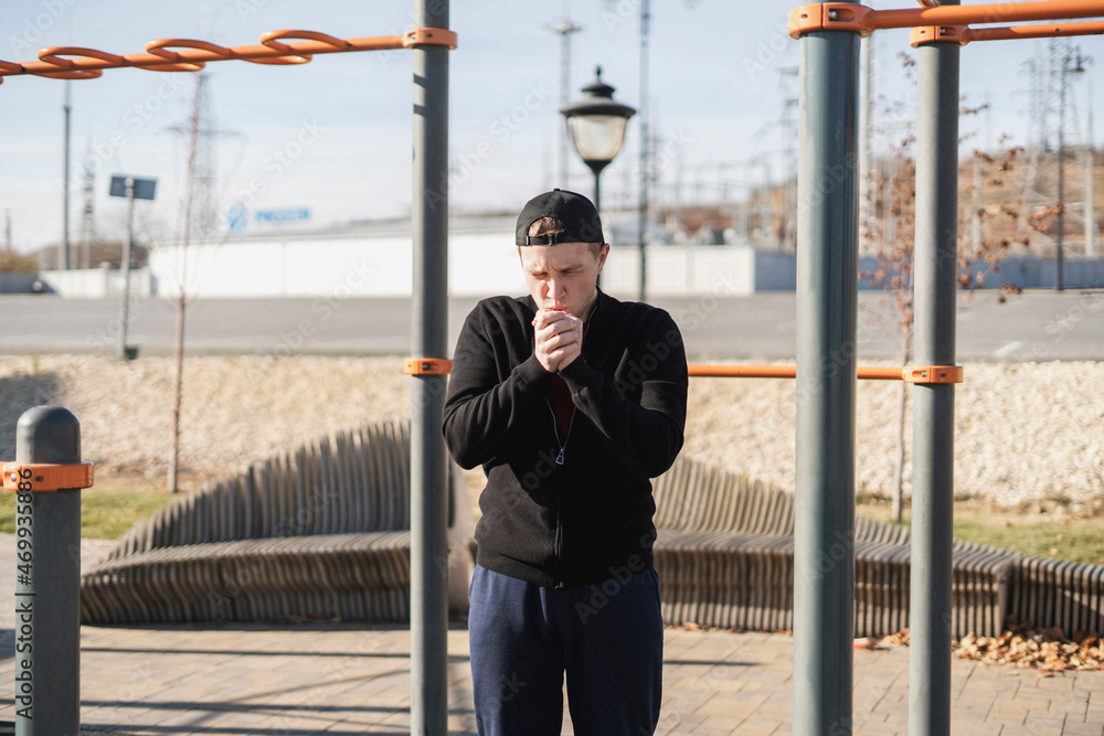 young sportsman on a pause break during workout process, warm up and having a rest