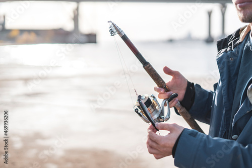 fisherman hands setting the fishing bait wobbler on the spinning rod
