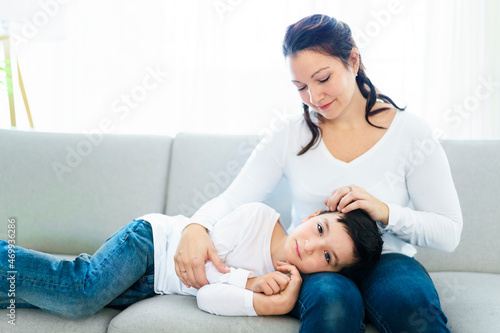 Mother with her son having fun in living room at home