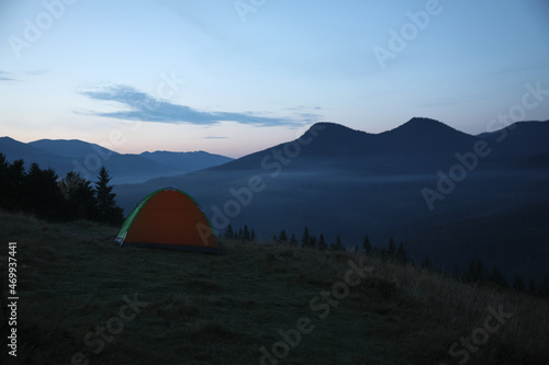 Camping tent on mountain slope in morning