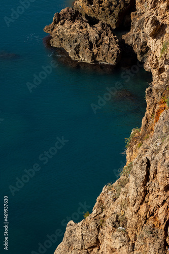 High rocks and blue sea background