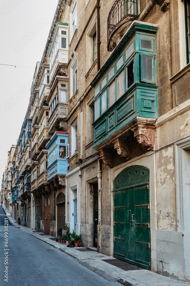 Traditional colorful Maltese doors in Valletta. Front doors to houses from Malta. Blue green doors and wooden balcony. Maltese vintage apartment buildings.Popular travel destination. Entrance to house