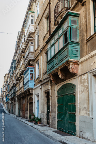 Traditional colorful Maltese doors in Valletta. Front doors to houses from Malta. Blue green doors and wooden balcony. Maltese vintage apartment buildings.Popular travel destination. Entrance to house © Eva