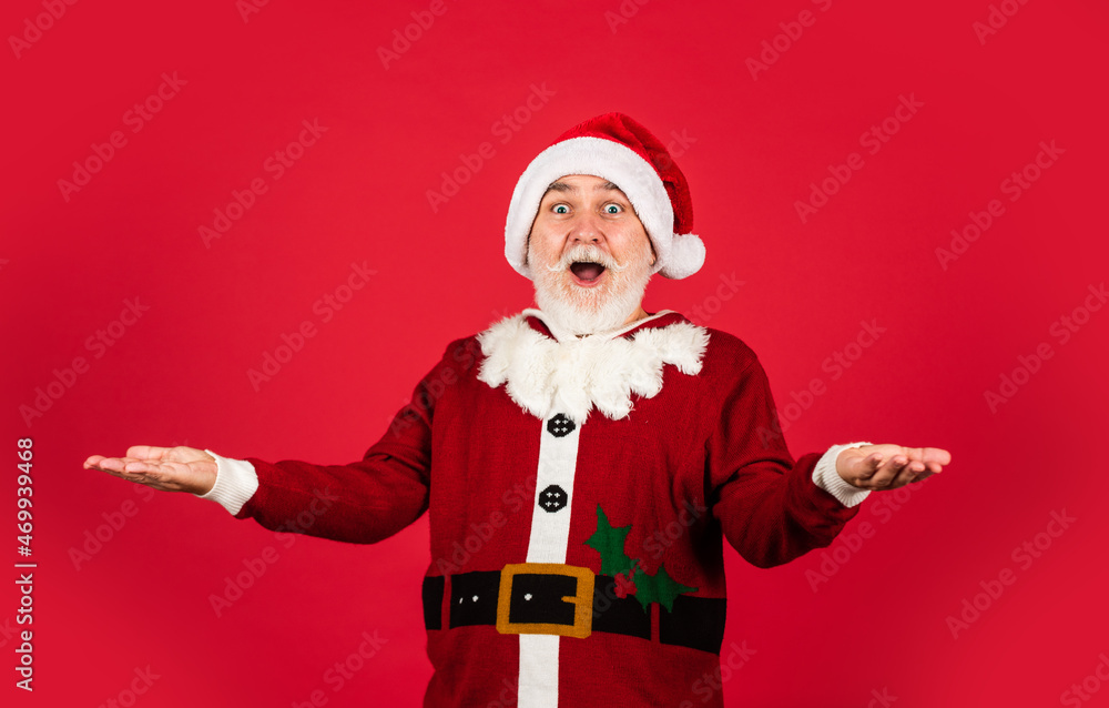 You are next. xmas presents and gift shopping time. winter holiday joy. funny senior man in santa claus costume. happy new 2021 year. merry christmas. bearded santa in hat on red background