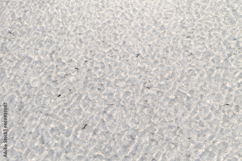 abstract texture of broken white ice. View of the ice from a drone.