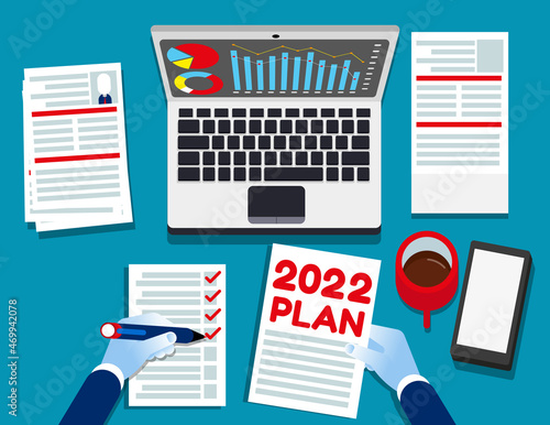 2022 plan text with office accessories. Top view for above