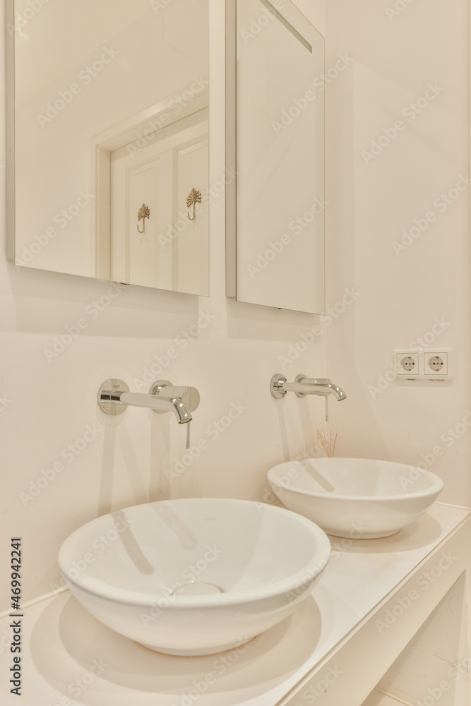 White sinks in light bathroom White sinks in light bathroom