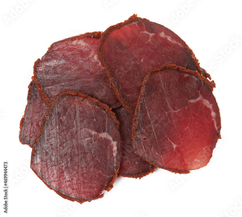 Delicious dry-cured beef basturma slices on white background, top view photo