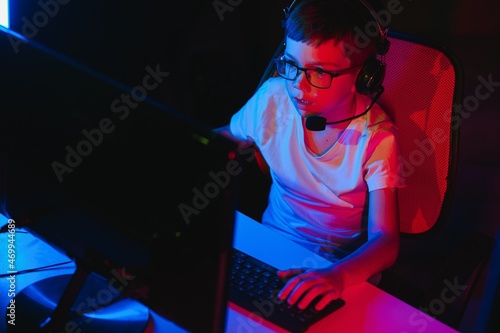 Little boy playing video game in the dark room © Serhii