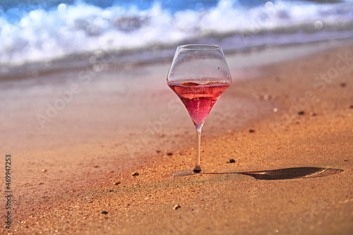 Wine glass with a cocktail by the sea.