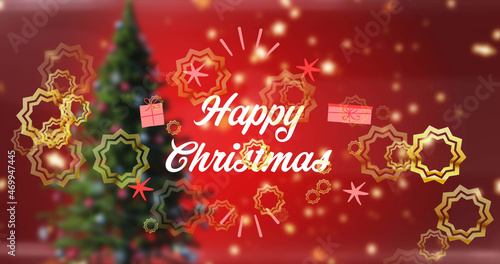 Image of happy christmas text in white  with gold stars over christmas tree on red background