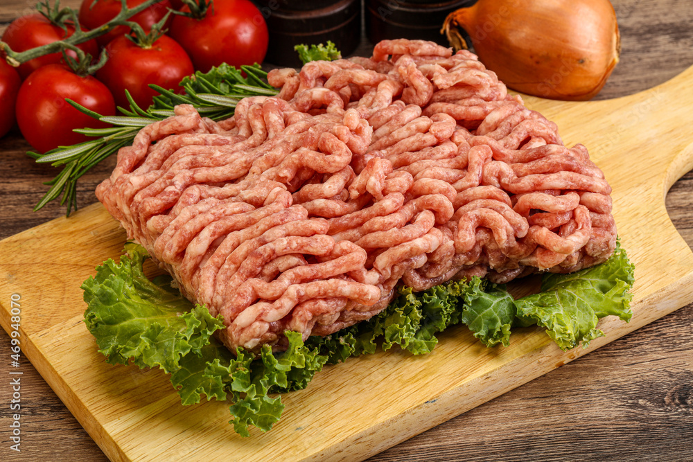 Raw pork minced meat over board Raw pork minced meat over board