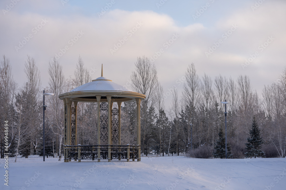 Gazebo in the snow-covered park in the morning. Gazebo in the snow-covered park in the morning.