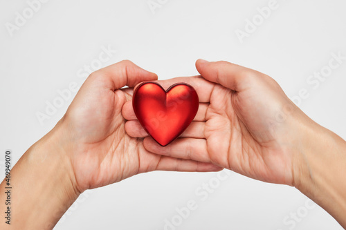 Hands holding red heart  close-up  white background