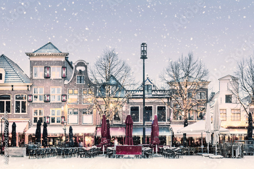 Winter snow view of the famous Dutch Waagplein with pubs and restaurants in Alkmaar, The Netherlands photo