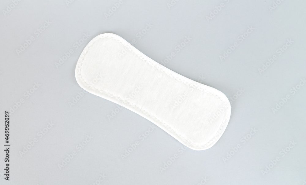 Natural daily sanitary pad or pantyliner top view on gray background Natural daily sanitary pad or pantyliner top view on gray background