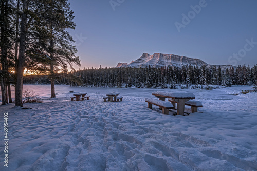Sunrise on picnic tables and Mount Rundle at Johnson Lake in Banff National Park, Alberta, Canada