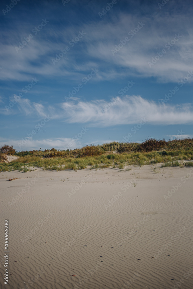 sand dunes and beach against the blue sky