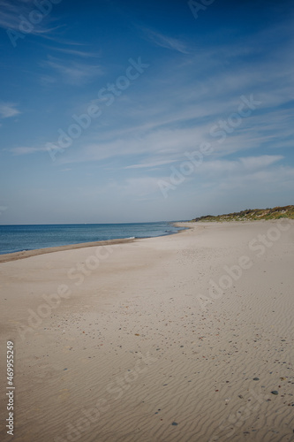 sand dunes and beach against the blue sky