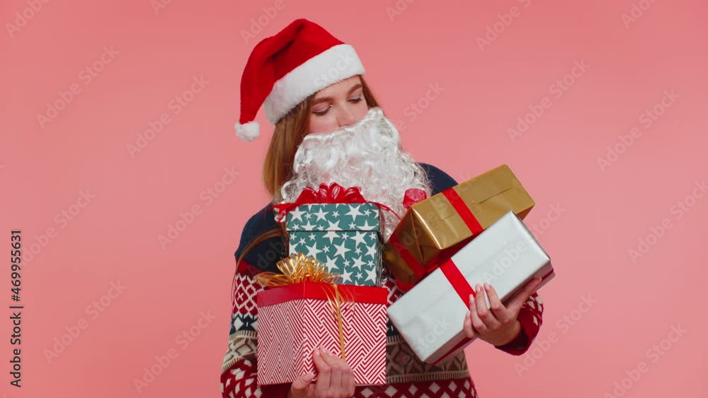 Girl in Christmas fake beard of Santa Claus looking surprised at mount of boxes hands excited by so many holiday gifts, lot of presents. Happy New Year presents shopping sale celebration merry holiday Girl in Christmas fake beard of Santa Claus looking surprised at mount of boxes hands excited by so many holiday gifts, lot of presents. Happy New Year presents shopping sale celebration merry holiday