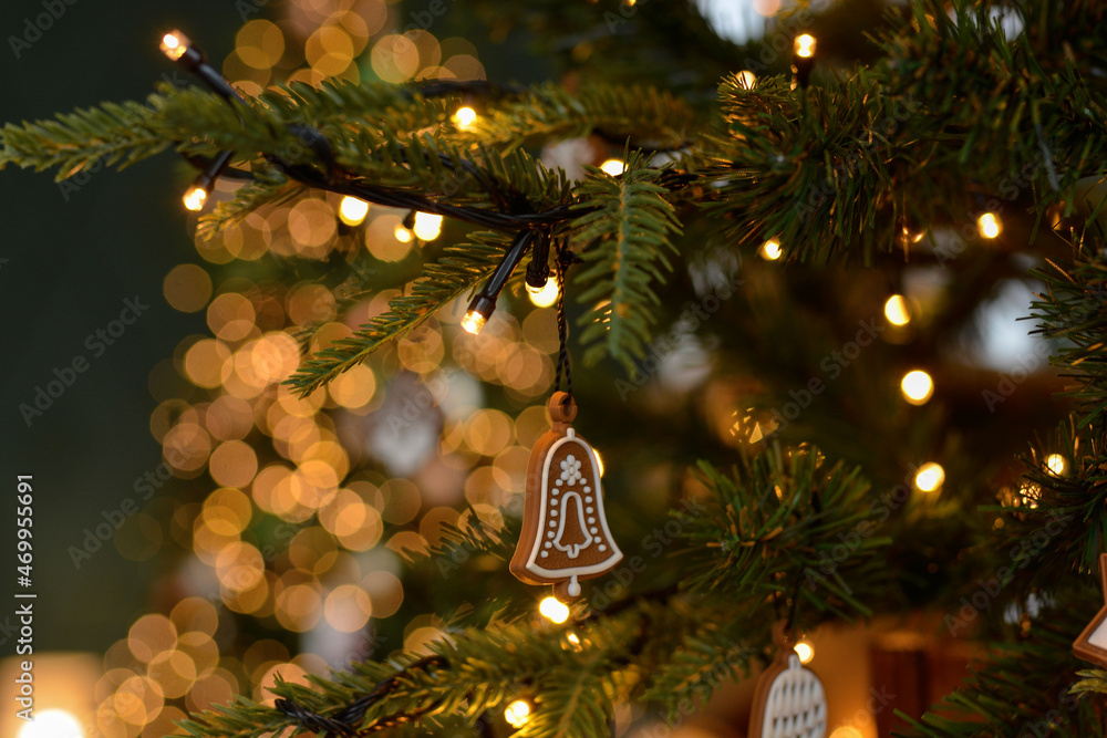 Christmas gingerbread decoration on a Christmas tree on golden bokeh background Christmas gingerbread decoration on a Christmas tree on golden bokeh background