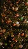 Luxury decorated Christmas tree with gold, green, brown balls, beads, garland. Christmas decorations. Happy New Year and Merry Christmas!
