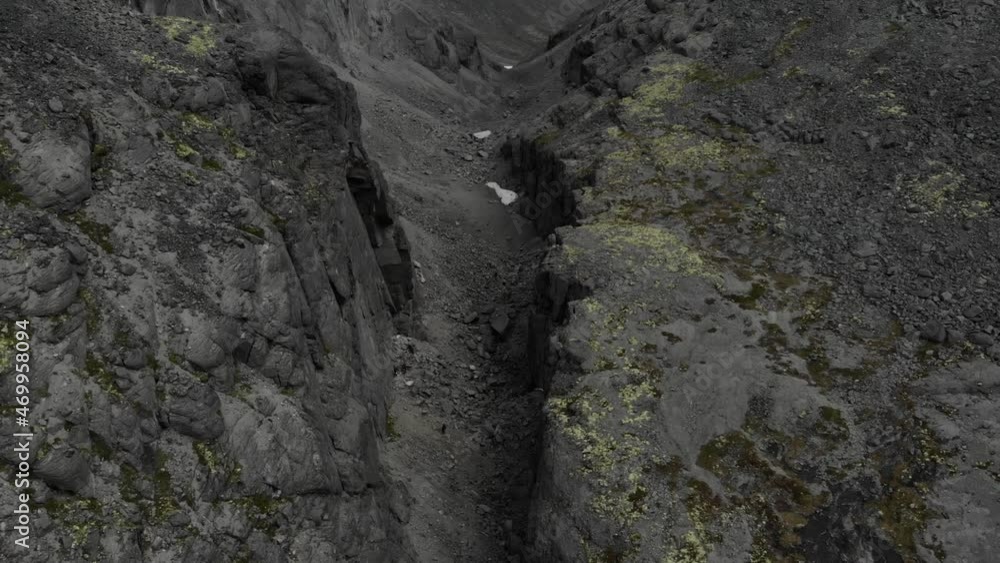 A round view of gray stone canyon with a dry riverbed opening from a high place A round view of gray stone canyon with a dry riverbed opening from a high place