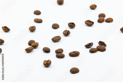 brown red coffee beans not roasted on white background, focus is in the middle of the picture, studio shot