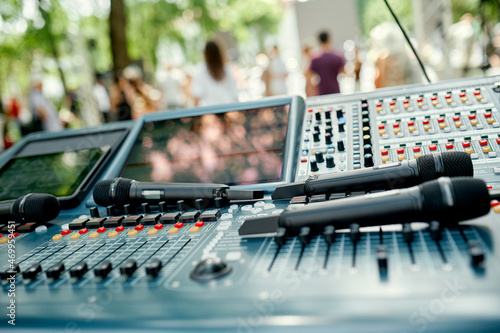 Microphones are on the sound console on the street before a live performance photo