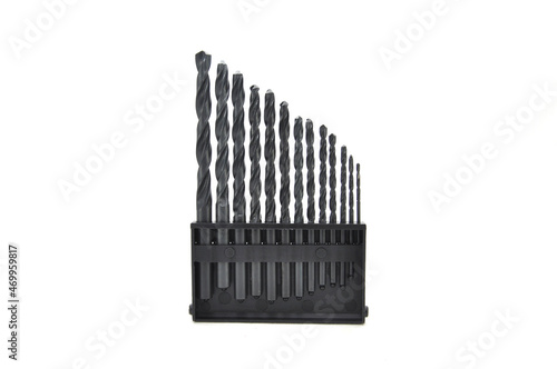 Black drill bit on white background close-up. Tool, drilling, technology, consumables, macro, sharp, black, sharpening