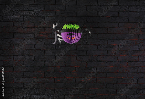 colored paper halloween spider on black brick wall