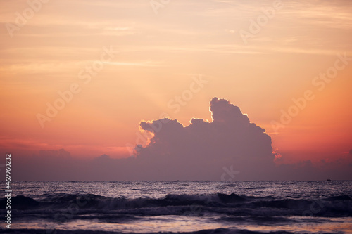 Dramatic clouds over horizon of Indian ocen during sunrise. Colorful natural seascape with copy space..