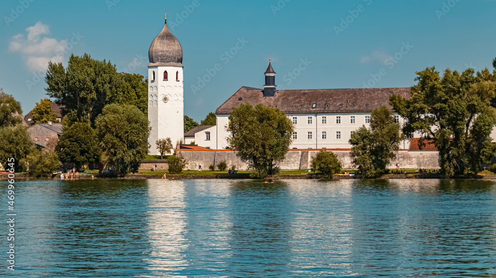 Beautiful church with reflections in the lake at the famous Fraueninsel, Chiemsee, Bavaria, Germany