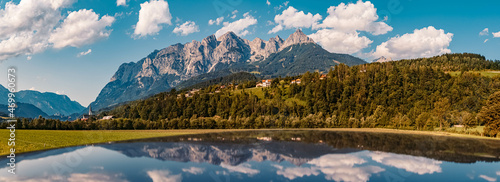 High resolution stitched panorama of a beautiful alpine summer view with reflections on a car roof and the famous Tennengebirge mountains in the background near Pfarrwerfen, Salzburg, Austria