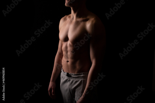 Man Showing ABS. Muscle man Posing. Strong Body Concept. Topless Sport man Bodybuilder. Six Pack Spotsman