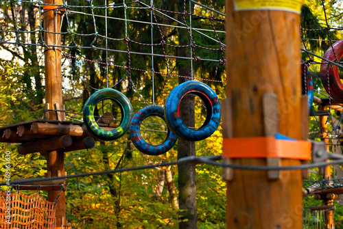 Rope park for children. Extreme outdoor entertainment. Slings, ropes and wires are tied to trees.