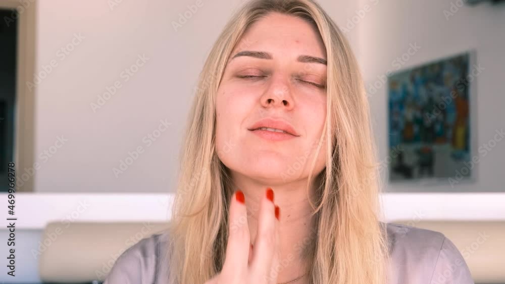 Natural beauty and self-care in 30 years. Portrait of a young beautiful blonde woman gently touching her face, looking into the camera. 4k, slow motion Natural beauty and self-care in 30 years. Portrait of a young beautiful blonde woman gently touching her face, looking into the camera. 4k, slow motion