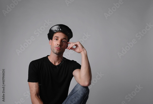Portrait of stylish young man with serious face expression. White background.
