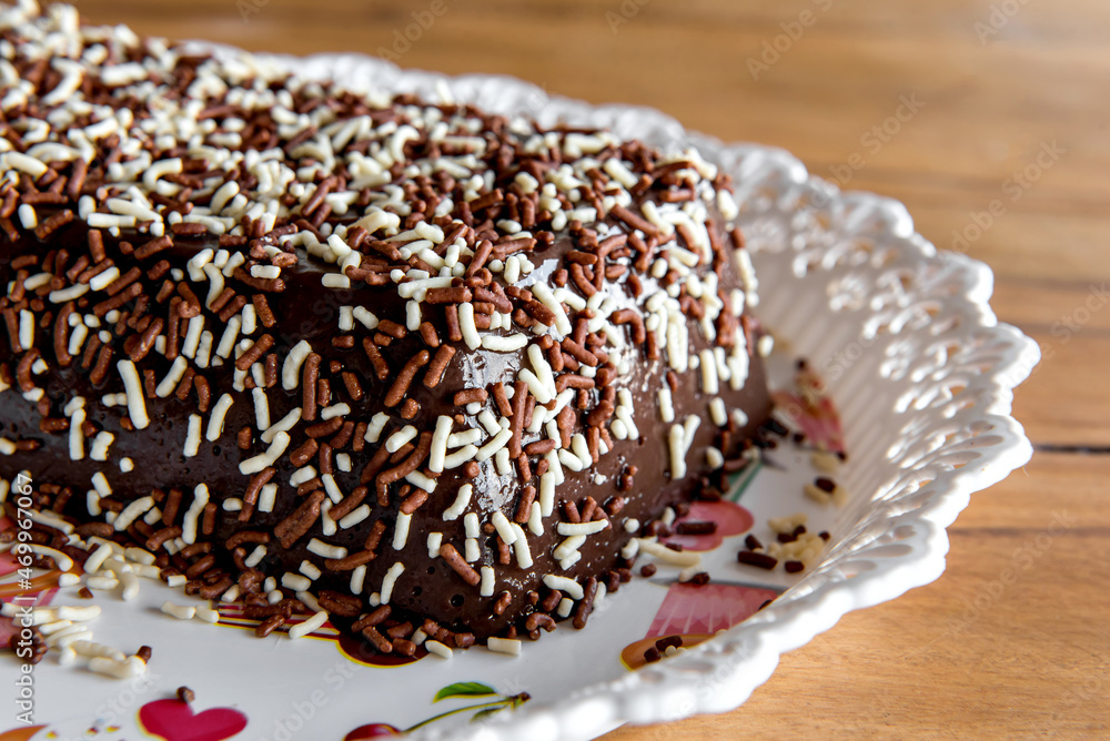 Chocolate pudding with sprinkles, delicious chocolate dessert on wooden table
