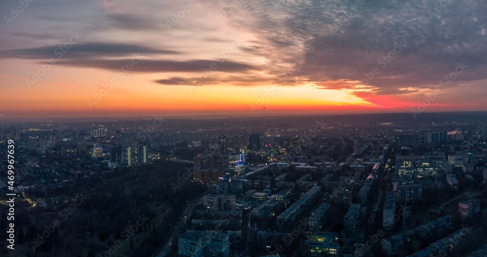 Aerial scenic vivid sunset view with dramatic skyscape panorama. Kharkiv city center, Pavlove pole residential district streets in blue evening light